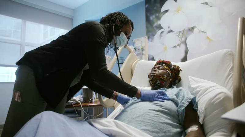 A Respiratory Therapist Checking a Patient's Breathing in A Hospital Room Using a Stethoscope