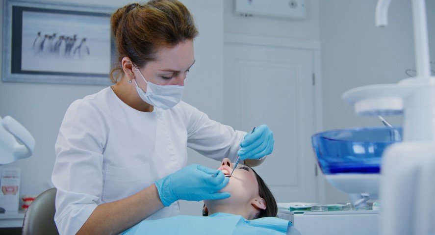 A dentist meticulously examines a patient's mouth