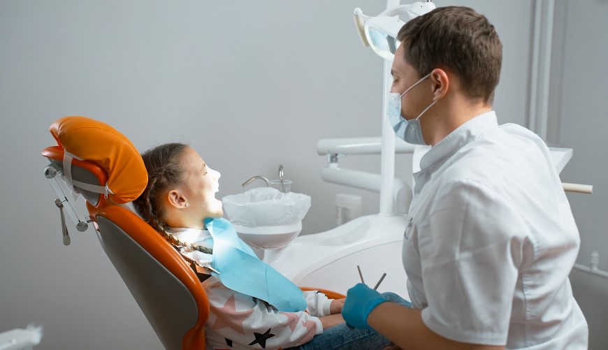 A young patient sits comfortably in the dental chair