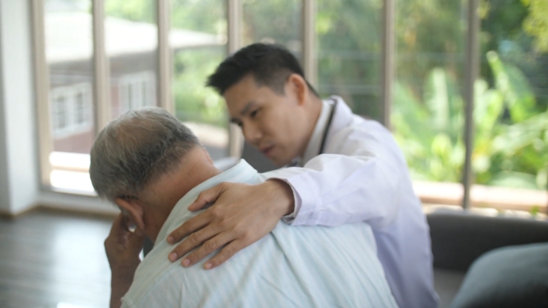 A doctor comforting an elderly patient, illustrating support for impulse control disorders