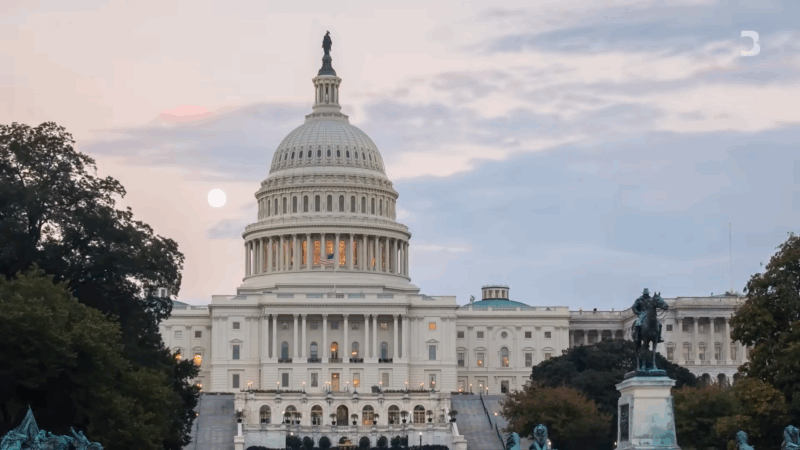 The U.S. Capitol building at dusk, with the American flag visible atop the dome