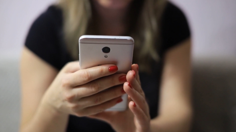 A person uses a smartphone, reflecting the growing trend of mobile-driven healthcare models