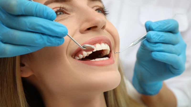 A woman receives a dental check-up, representing the cheapest cosmetic dental procedures available in popular global destinations
