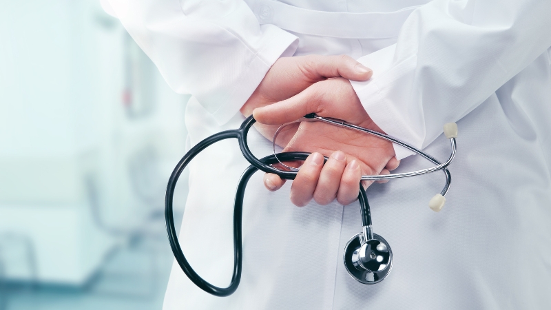 Doctor holding a stethoscope, showing medical care in a German hospital