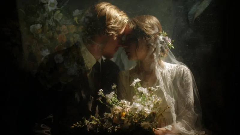 A couple sits closely together in wedding attire, symbolizing changing trends in the average marriage age in the US