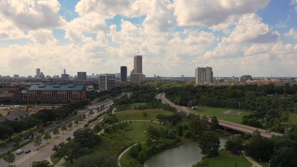 Aerial view of Houston skyline and green parkways under a partly cloudy sky, highlighting one of the top US cities to visit