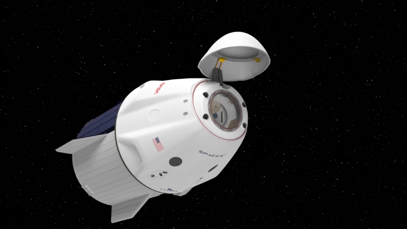 A SpaceX spacecraft orbits in space with its hatch open, showing part of the capsule interior