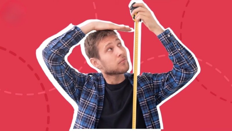 A man checks his height with a tape measure, raising the question of whether average human height is still increasing