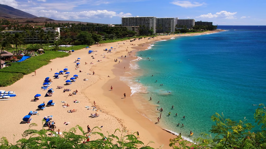 Wide view of Kaanapali Beach in Maui with turquoise water and beachfront resorts