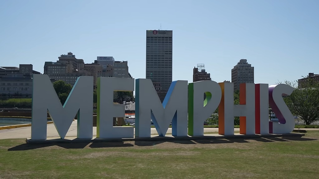 Colorful Memphis sign in downtown with city buildings behind it, showcasing one of the most culturally rich US cities to visit