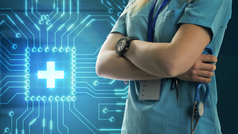 A healthcare professional stands with folded arms in front of a digital medical graphic representing large health datasets