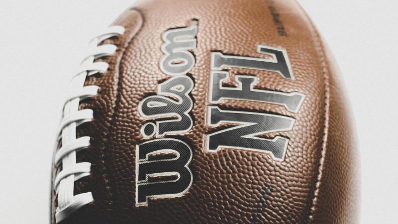 Closeup of an NFL football symbolizing 2024 team attendance by region