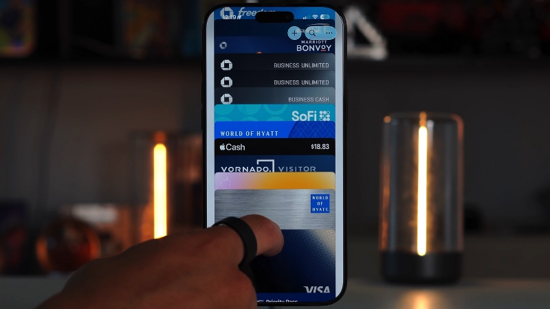 A person uses Apple Pay on an iPhone to access digital cards and payment options stored in the wallet app