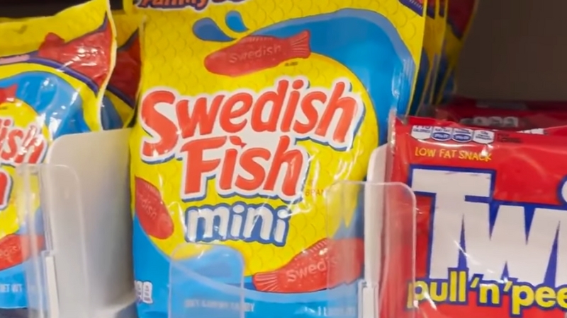 Bags of Swedish Fish and Twizzlers candy on a store shelf, products affected by FDA-approved natural food dye changes