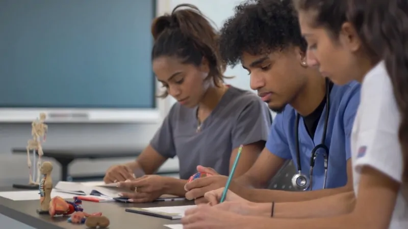 Medical students study together, reflecting the role of GPA and MCAT scores in medical school admission