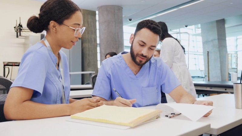Medical students review notes together