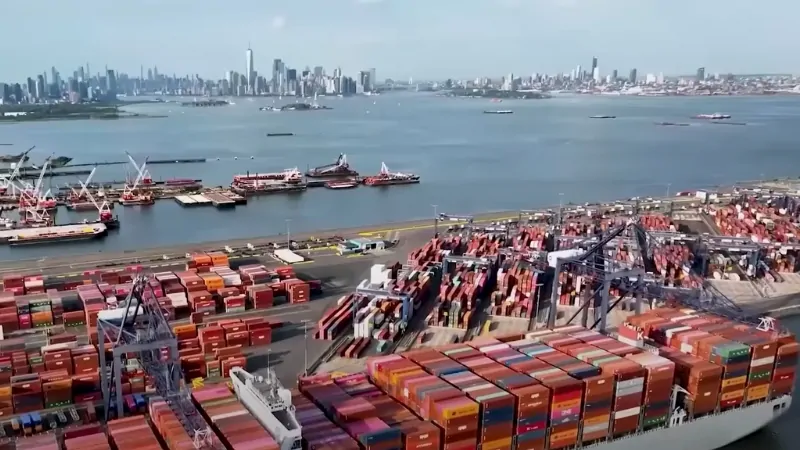 A busy shipping port with containers and cargo ships, reflecting global trade activity amidst U.S.-China trade tensions