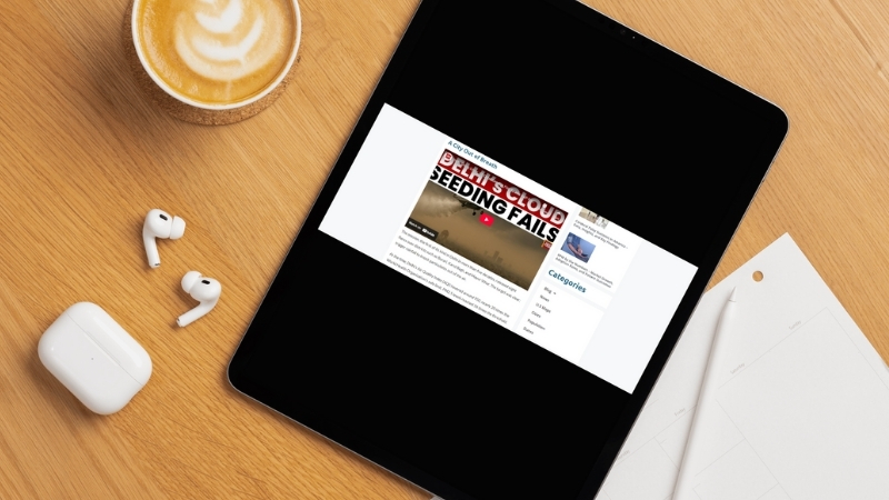 A tablet shows a news video about Delhi’s cloud seeding effort and the city’s severe smog crisis