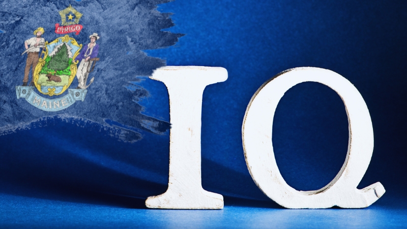 Large white IQ letters on a blue background with the Maine state seal behind them