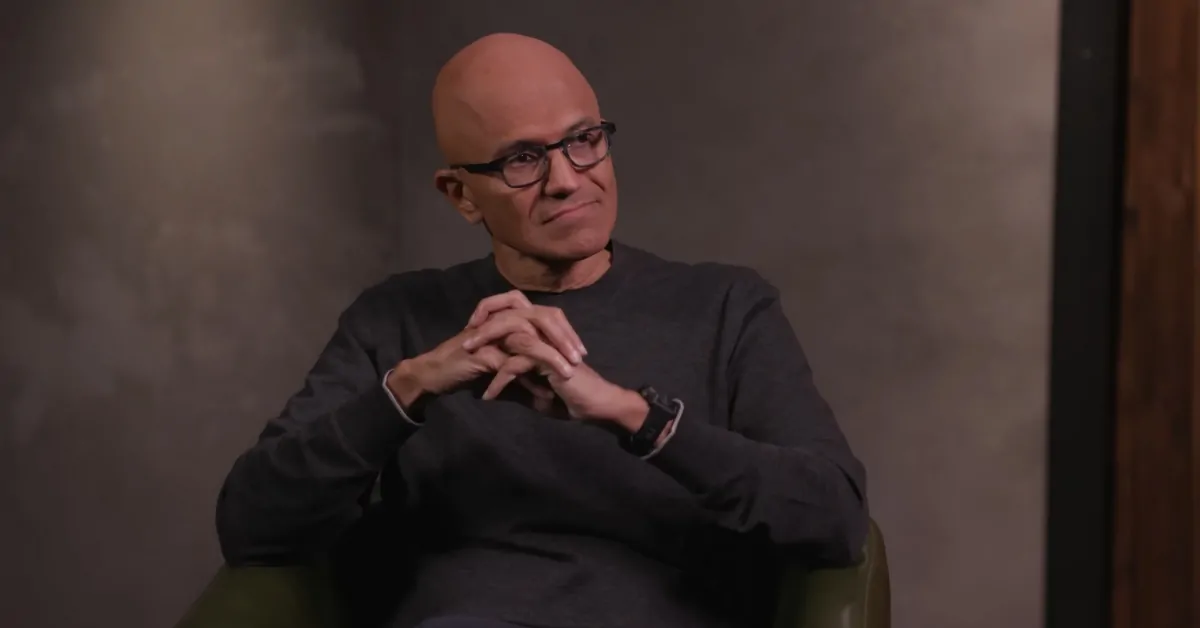 Microsoft’s CEO sits with folded hands during an interview