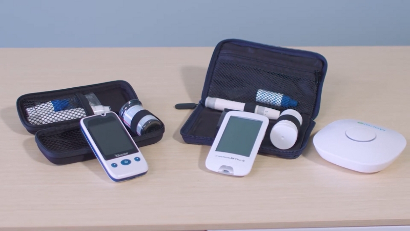 Remote patient monitoring kits with digital health devices and accessories arranged on a table for clinical use