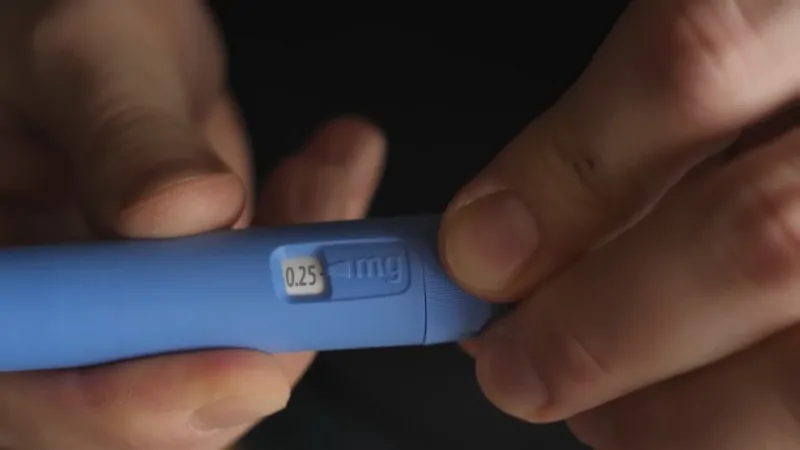 Hands adjust a 0.25 mg Ozempic pen