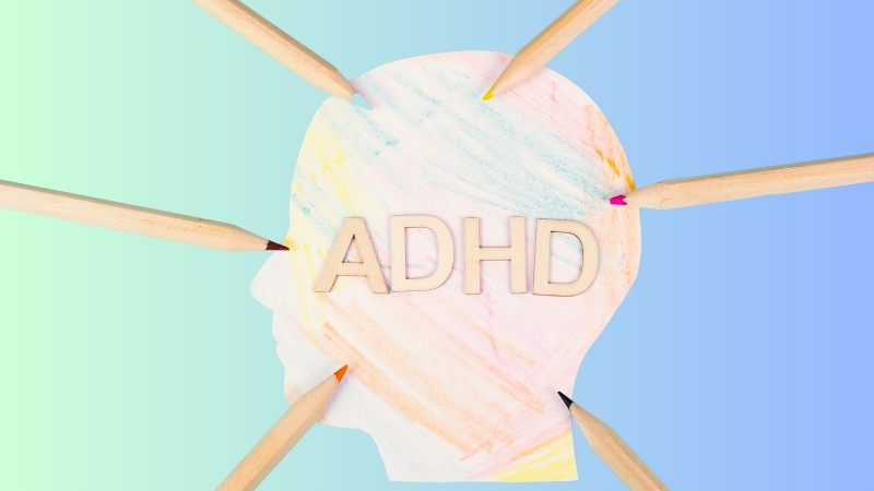 A head silhouette with the word ADHD surrounded by pencils