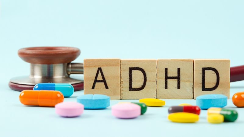 ADHD letters sit beside prescription pills and a stethoscope