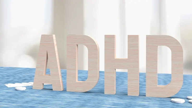 Large wooden letters spelling ADHD sit on a table