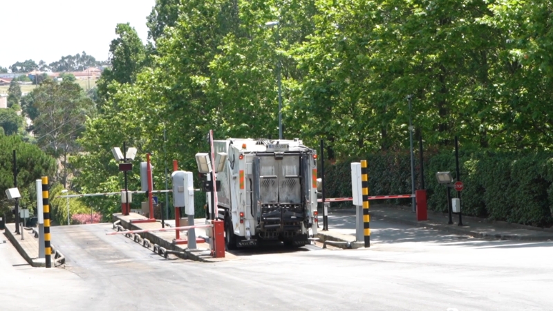 Garbage truck at a facility entrance, highlighting routine risks linked to sanitation work