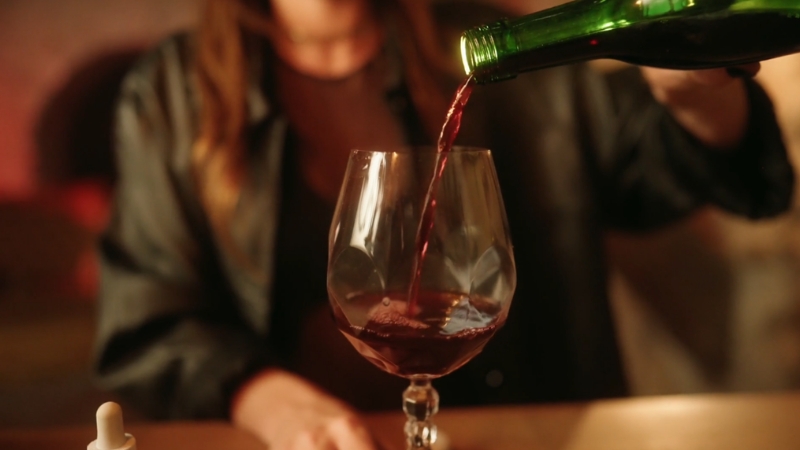 Wine pours into a glass to illustrate alcohol exposure and breast cancer risk