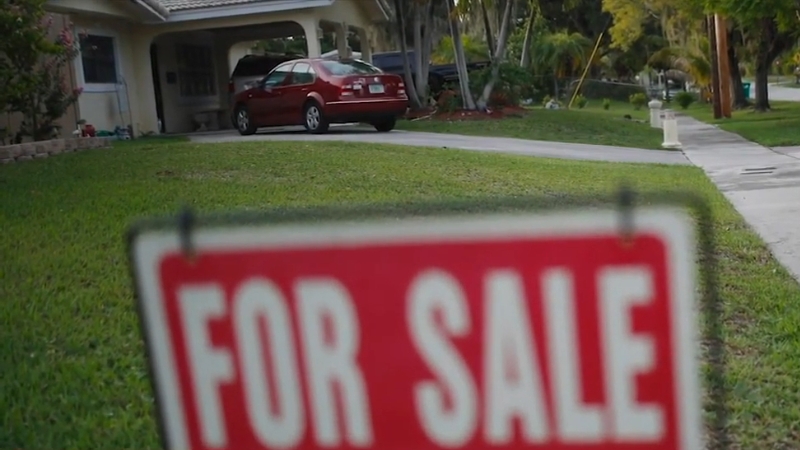 A for sale sign stands in front of a suburban home, symbol of owners who chose not to sell