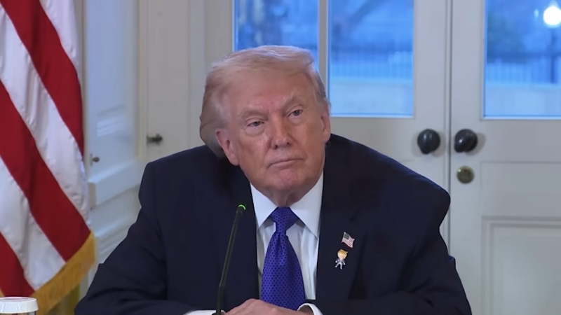 Donald Trump sits at a meeting table as his administration discusses a possible plan to acquire Greenland