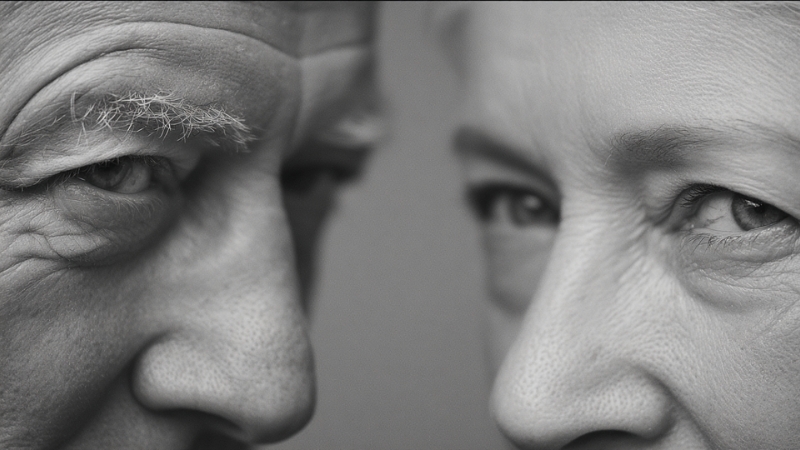 Close-up photo of an older man and woman facing each other