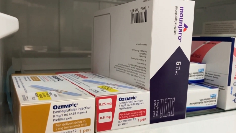 Boxes of Ozempic and Mounjaro GLP-1 medication pens on a pharmacy shelf