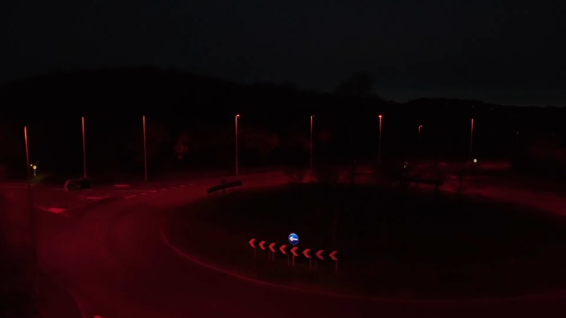 Red streetlights line a roundabout at night in Denmark as part of a wildlife-friendly lighting project