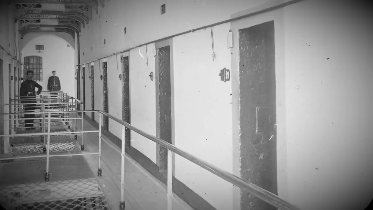 Black and white prison corridor with barred cells, often used to illustrate the Stanford Prison Experiment