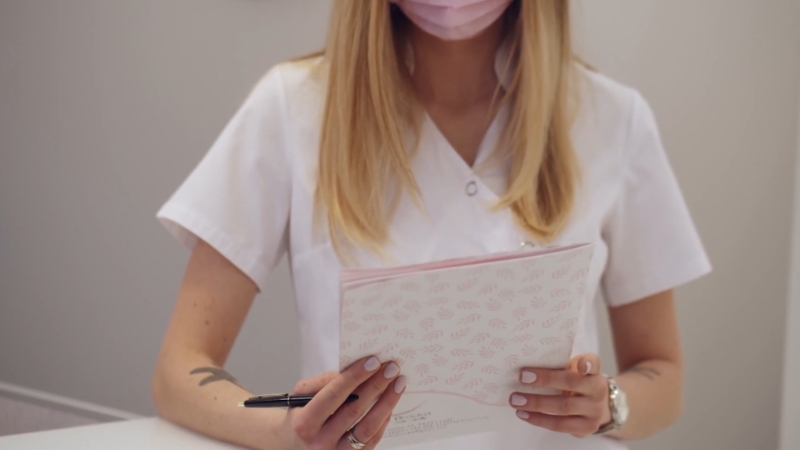 Healthcare professional reviewing paperwork, representing nurse vs physician career cost of education comparison