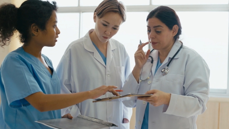 Nurse and physician reviewing a chart together