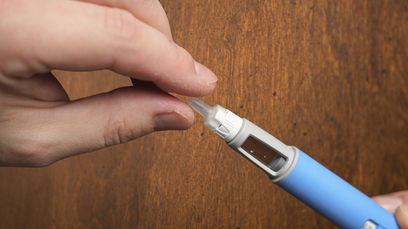 Close-up of a person holding an Ozempic injection pen before use