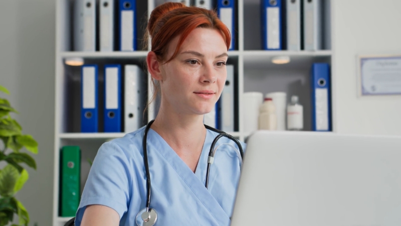 Clinician using a computer to complete PECOS setup and first-time Medicare enrollment