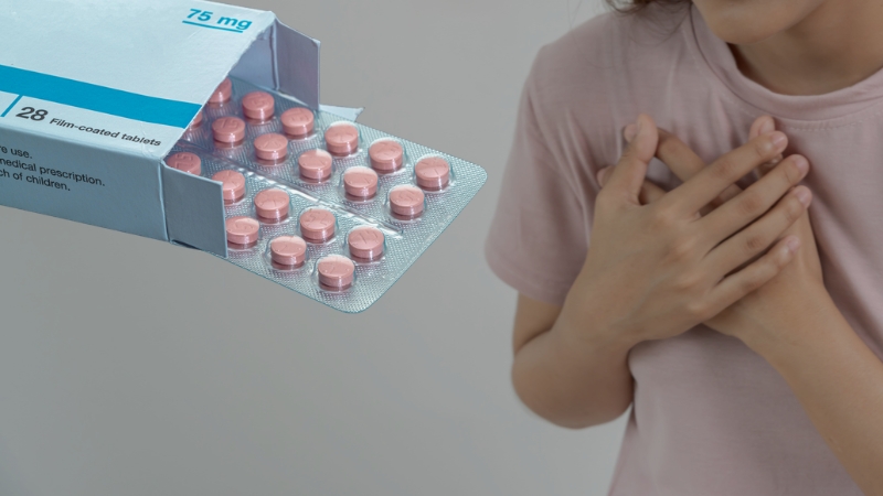 Box of 75 mg statin tablets next to a person holding their chest
