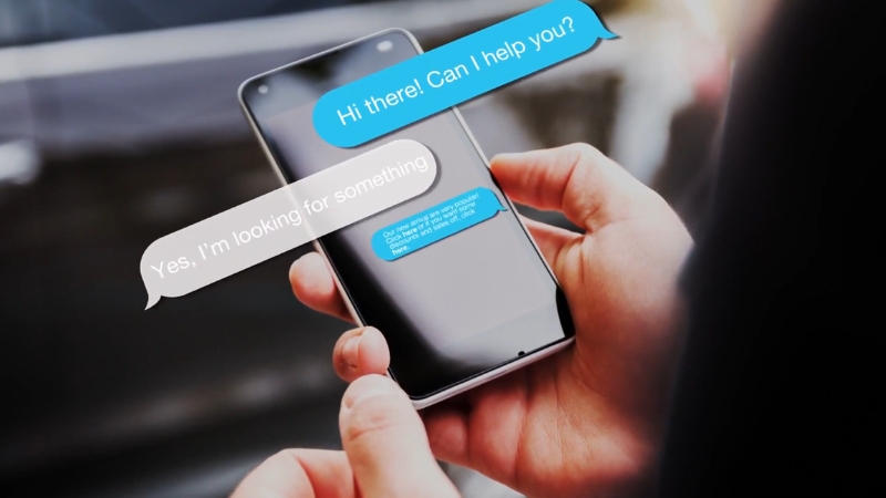 Person holding a smartphone with chatbot messages, representing future trends in customer support chatbots