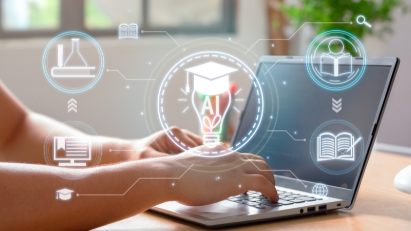 Person types on a laptop with AI education icons on screen