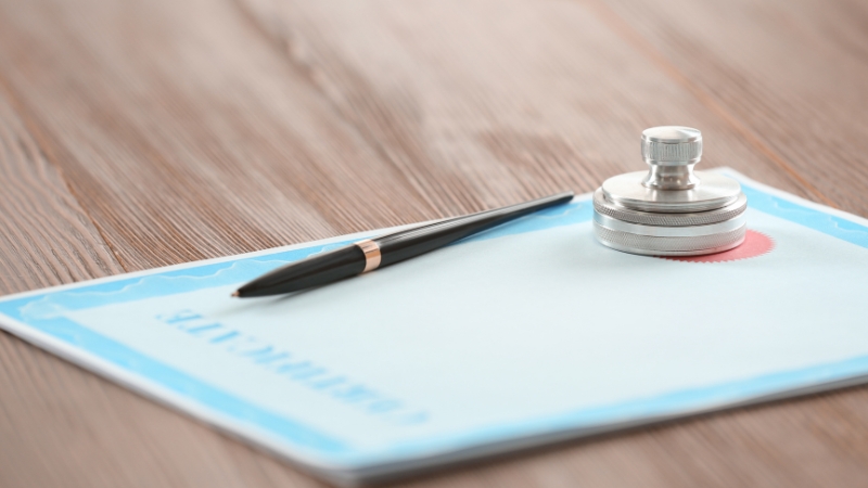 CACREP accreditation certificate on a desk with a pen and official seal