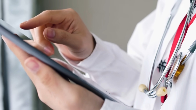 Doctor using a tablet, showing healthcare rankings by state