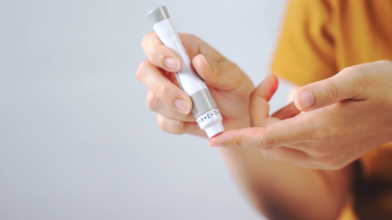 Person checking blood sugar with a glucose meter