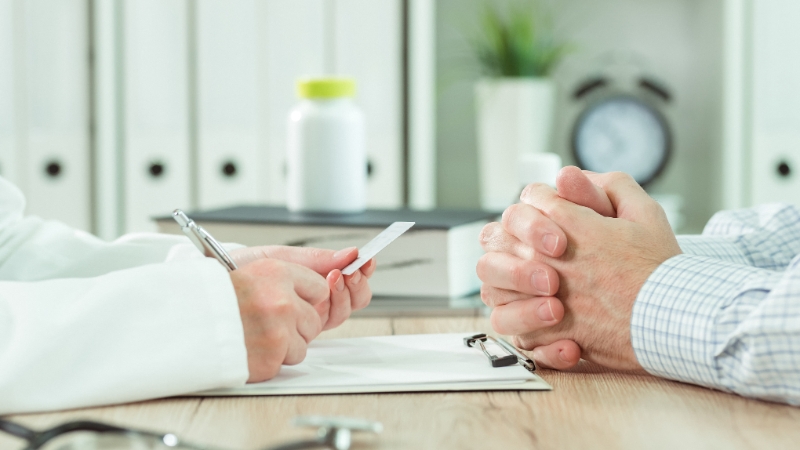 Doctor speaking with a patient about Emergency Medicaid coverage for illegal immigrants