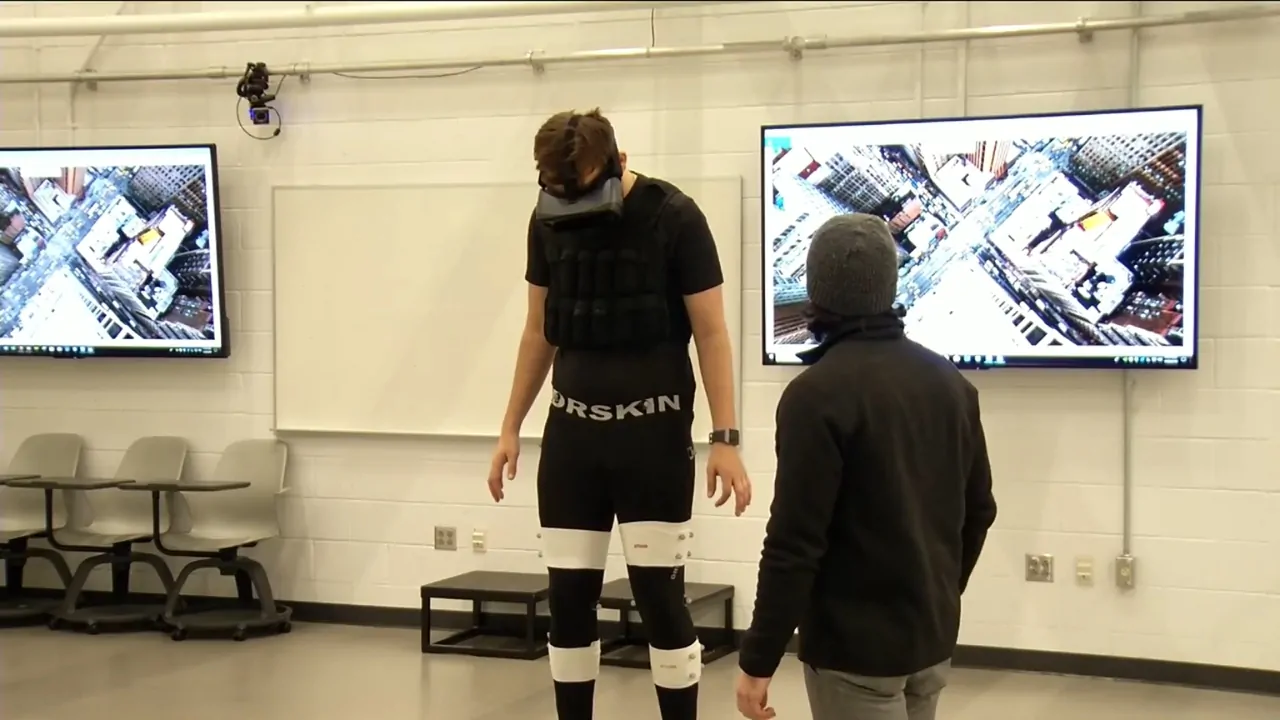 Person uses VR headset during ACL injury rehab session with therapist in lab setting