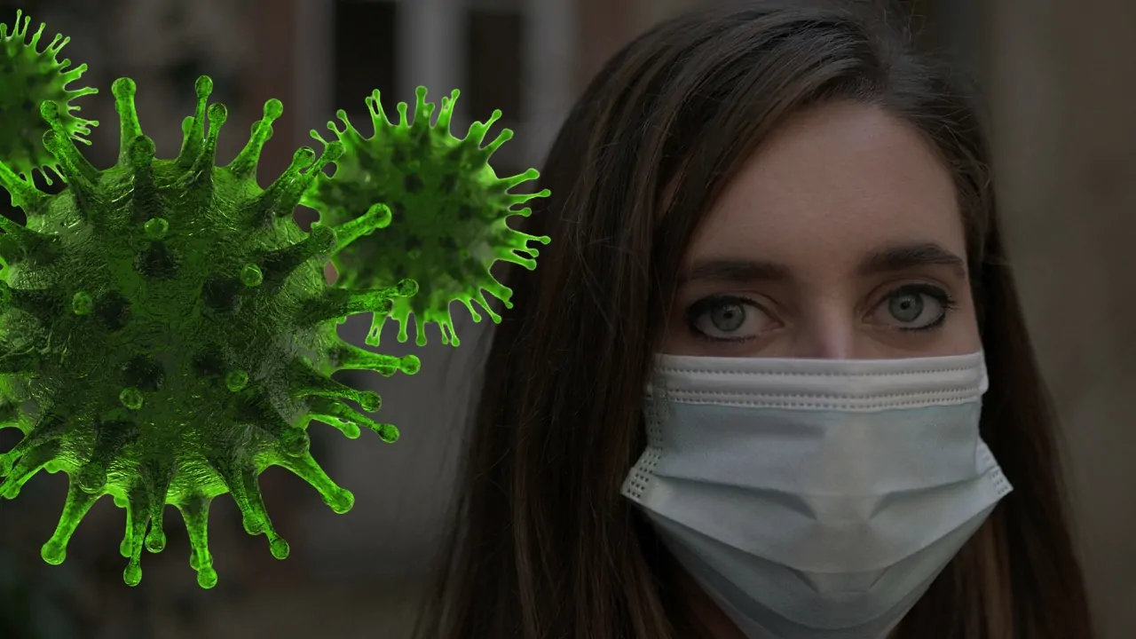 COVID variant BA.3.2 shown as green virus particles next to a woman with a face mask and serious expression